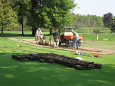 Sod is carefully cut and stacked in readiness for repositioning after work is complete.